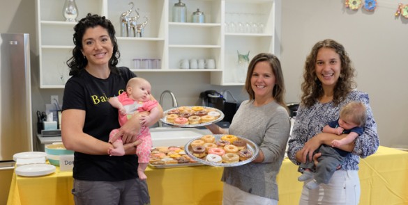 Lauren Drees, CNM, left, holding Violet Wills, Margaret Buxton, DNP, CNM, and Heather Sevcik, CNM, holding Oliver Blankenship, at the recent open house celebrating Baby+Company’s 100th birth. (photo by Josh Reeder)