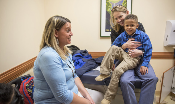 Elizabeth Speck, M.D., holds patient Jeremiah Bevis while talking with the boy’s mother, Ashley Bevis, during a recent appointment at Monroe Carell Jr. Children’s Hospital at Vanderbilt’s Complex Urinary and Bowel Issues (CUBI) Clinic. (photo by John Russell)