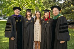 Commencement was a busy day for Jeff Balser, M.D., Ph.D., right, and his family, several of whom took part in graduation. From left are son James (Law School), daughter Jillian (School of Medicine), daughter Maddie and wife Melinda (Divinity School). (photo by Daniel Dubois)