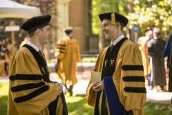 Ryan Craven, Ph.D. (Microbiology and Immunology), left, and Justin Siemann, Ph.D. (Neuroscience), chat before the Graduate School ceremony. (photo by Daniel Dubois)