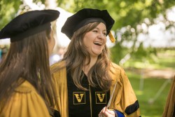 Meghan Joly, Ph.D. (Cancer Biology), right, shares a laugh with fellow student Rebecca Klar, Ph.D. (Pharmacology), before the Graduate School Commencement. (photo by Daniel Dubois)