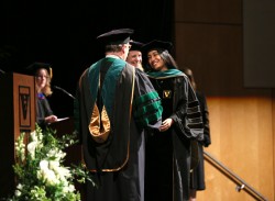 Leonela Villegas is congratulated by C. Wright Pinson, MBA, M.D., at the School of Medicine ceremony. (photo by Anne Rayner)
