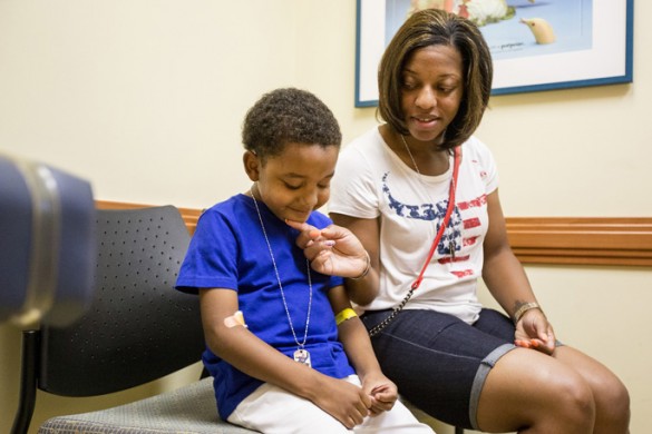 Liver transplant patient Antwane Cole Jr. and his mother, Monjineh Singer, share a moment during a recent follow-up visit to Monroe Carell Jr. Children’s Hospital at Vanderbilt. (photo by Joe Howell)
