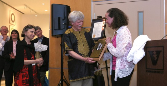 Maggie and John Tarpley, M.D., accept a plaque from Kyla Terhune, M.D., at a recent reception honoring Tarpley's career at Vanderbilt. (photo by Anne Rayner)