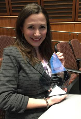 Karina Maza, with her award from the International Medical Interpreters Association.