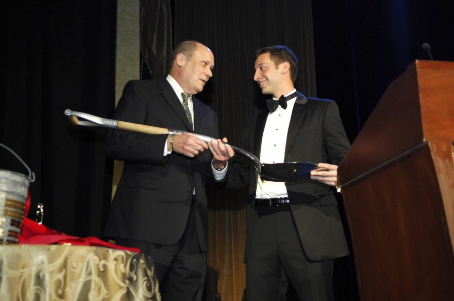 James Atkinson, M.D., left, is presented the Shovel Award for teaching by Scott Zuckerman, president of the VUSM class of 2012.