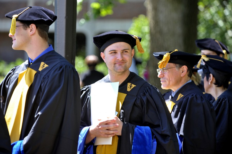 Andrew Benesh gets ready for the Graduate School ceremony on Library Lawn. (photo by Joe Howell)
