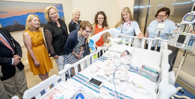 Grace Dalby, 2 months, was the first patient moved in to the new space at Monroe Carell Jr. Children’s Hospital at Vanderbilt. Here, she is greeted by Meg Rush, MD, MMHC , Edie Carell Johnson, left, Kathryn Carell Brown, Julie Carell Stadler, Grace’s mother, Meredith, Deena Stalnaker, RN, and Michelle Acton, MSN, RN.