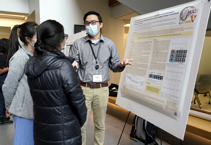 Leon Cai explains his poster to Sharon Kam (center) and Katherine Lee at the 2022 Alzheimer’s Disease Research Day.