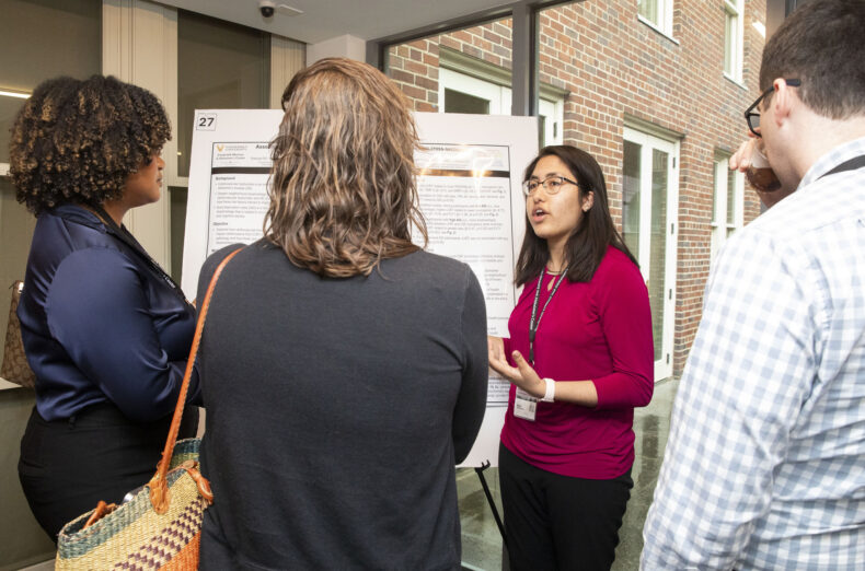 Brina Ratangee talks about her poster during Alzheimer's Disease Research Day. (photo by Susan Urmy)