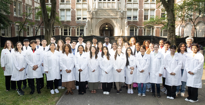 The 2023 Aspirnaut summer research interns, flanked by the program’s co-founders, Julie Hudson, MD, left, and Billy Hudson, PhD, back row, right. (photo by Susan Urmy)
