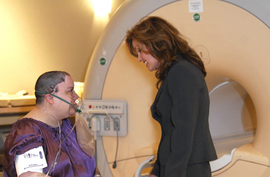 Megan Strother, M.D., talks with patient Debra Patterson before her recent BOLD fMRI neuroimaging scan. The new technique, which takes only 15 minutes, tracks how close brain tissue is to exhausting its supply of blood. (photo by Anne Rayner)