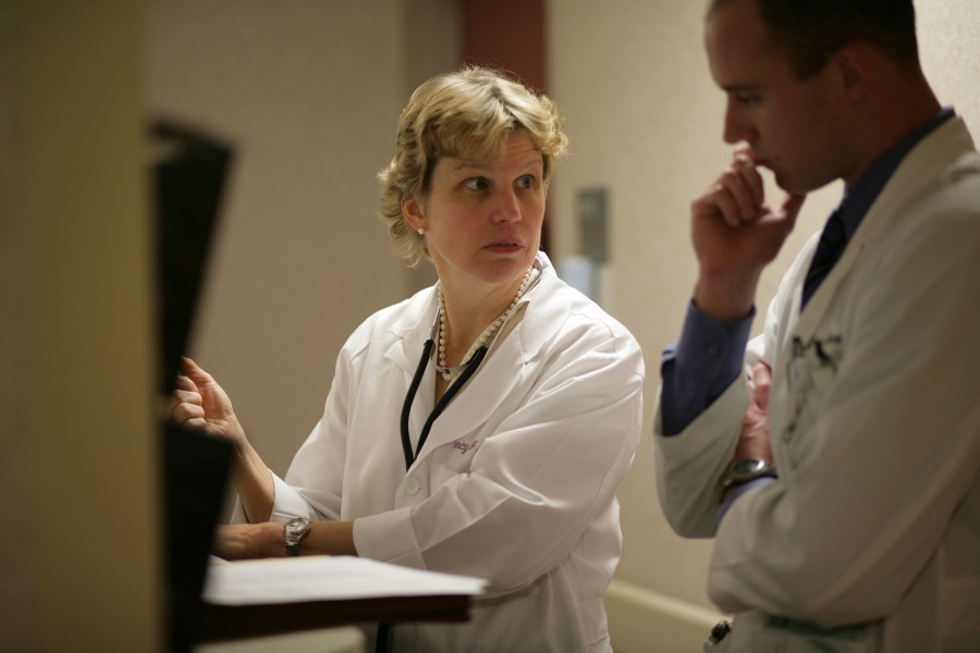 Brown reviews a patient’s case with S. Scheaffer Spires, M.D., during clinic rounds. (photo by Daniel Dubois)