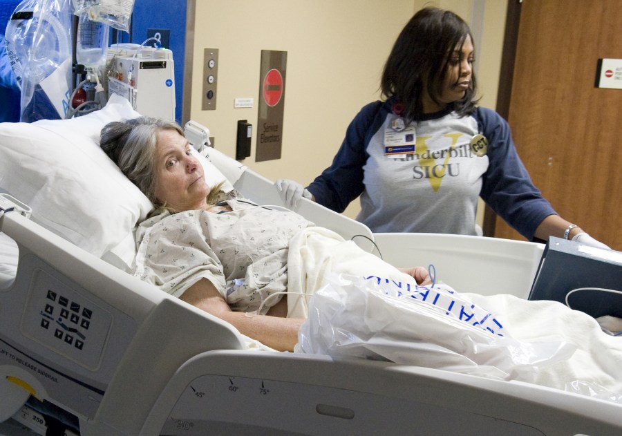 Respiratory Care’s Vanessa Hennings-Williams, right, makes sure patient Deborah Guffey is comfortable on her way to the new Surgical Intensive Care Unit.