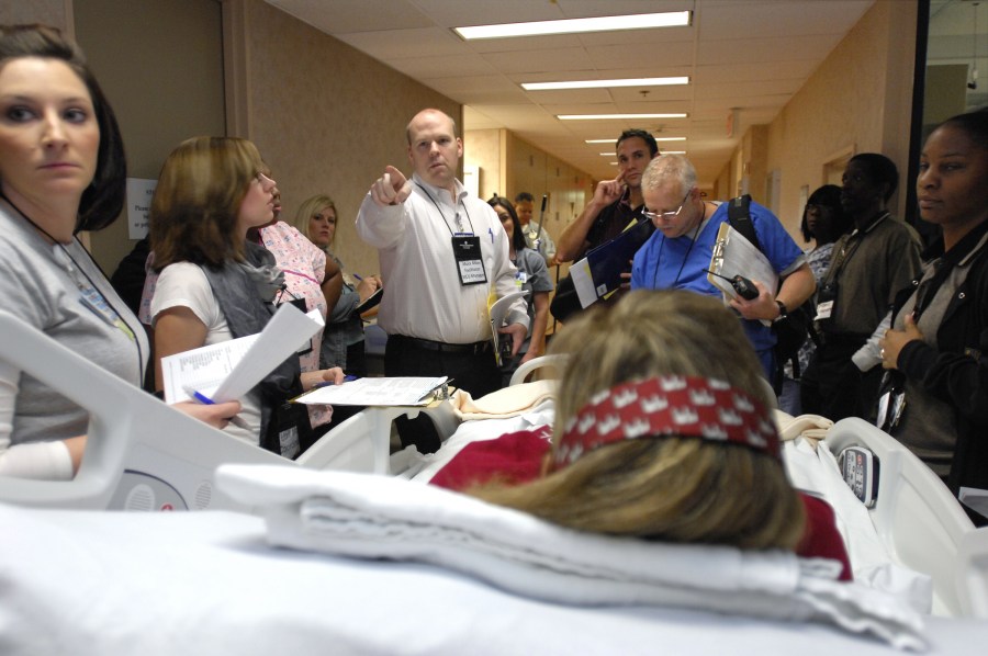 Mike Daly, M.S.N., R.N., points out the proper route during Saturday’s mock move exercise. (photo by Anne Rayner)