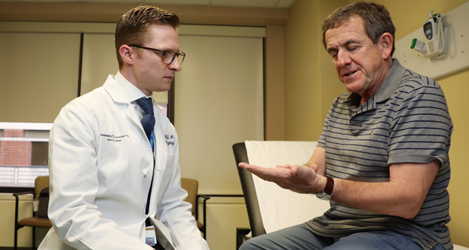Brad Hill, MD, left, recently performed minimally invasive carpal tunnel release surgery for Tommy Rainey. The procedure allows patients to return to work and regular activities sooner than a traditional, open procedure. 