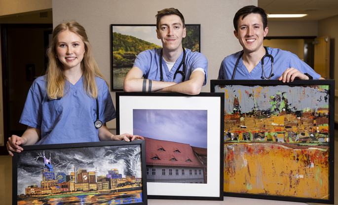 Vanderbilt University School of Medicine students, from left, Sophie Schellhammer, Wyatt Cole and Mike Libre formed a program that brings artwork into the rooms of patients at Stallworth Rehabilitation Hospital.