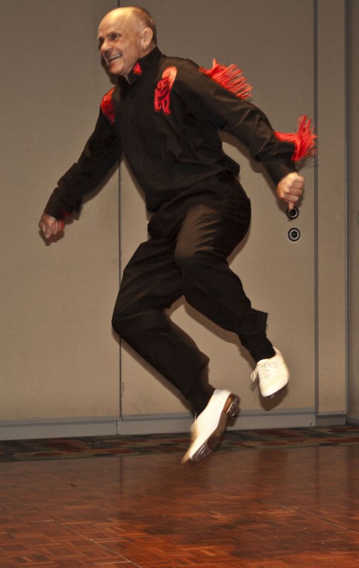 Jackie Corbin, Ph.D., gets airborne while clogging during his retirement celebration. (Photo by Ken Grimes)