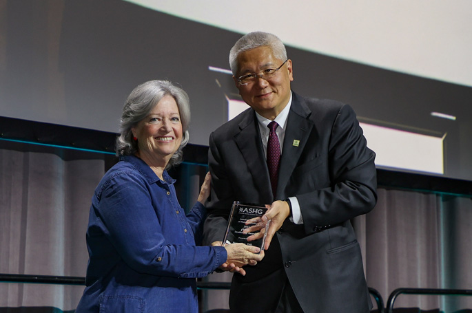 Nancy Cox, PhD, receives the American Society of Human Genetics Leadership Award from ASHG president Brendan Lee, MD, PhD. Photo courtesy of ASHG.