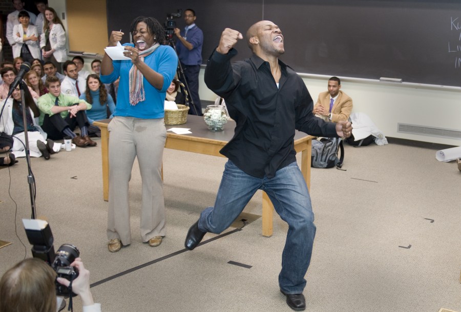 Walter Wakwe jumps for joy after his wife, Candy, reveals they are headed Emory University School of Medicine. (photo by Joe Howell)