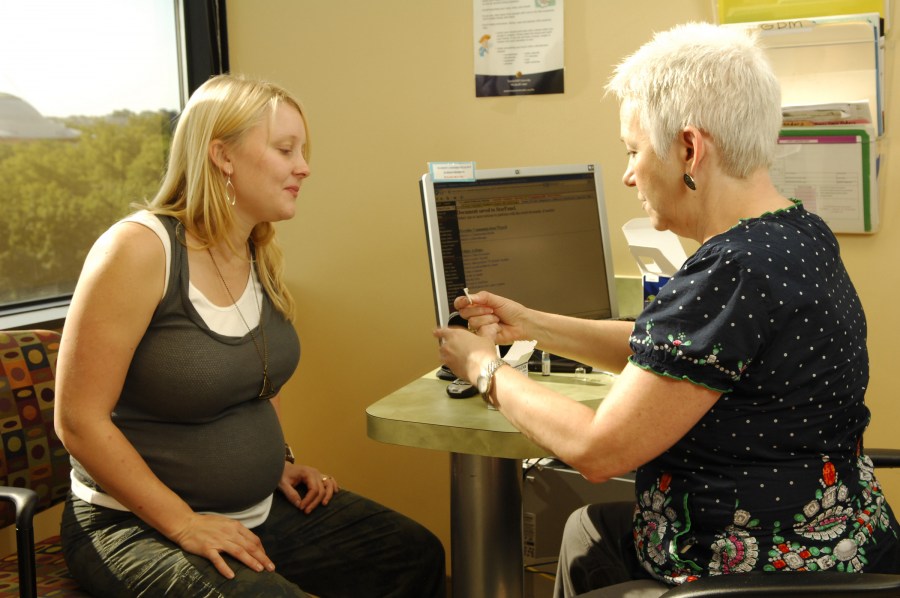 Patricia Patterson, R.N., CDE, right, teaches gestational diabetes patient Sarah Rose how to use a glucometer to monitor her blood sugar. (photo by Anne Rayner)