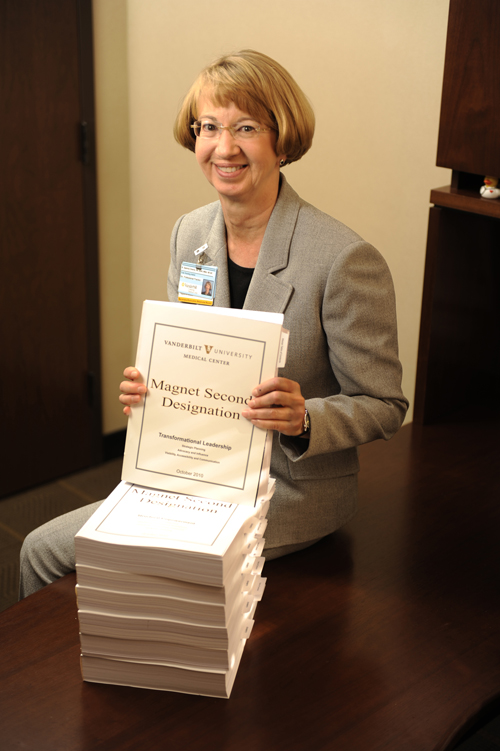 Sabrina Downs, MSN, MBA, RN, NE-BC, with the documents submitted for VUMC’s second Magnet designation in 2012.