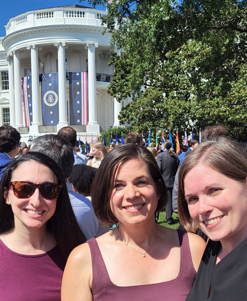 Stacie Dusetzina, PhD, right, on the South Lawn of the White House with colleagues Rachel Sachs, JD, MPH, of Washington University St. Louis, left, and Michell Mello, PhD, of Stanford.