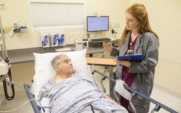 Vanderbilt University student Kate Sborov works with patient Wendell Crouch through VUMC’s new Immersion in Emergency Care Research course for undergraduate students. (photo by John Russell)