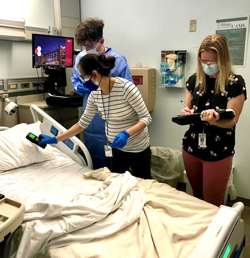 Epidemic Intelligence Service officers check the humidity and take samples from linens in a patient room while investigating a hospital-associated mucormycosis outbreak in Little Rock, Arkansas, in March 2021.