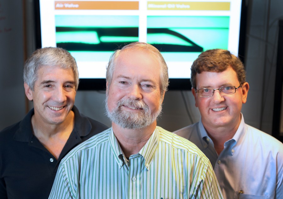 The principal investigators on the Extractionator project are biomedical engineer Rick Haselton, Ph.D., front, biochemist Ray Mernaugh, Ph.D., left, and chemist David Wright, Ph.D.  (photo by Susan Urmy)