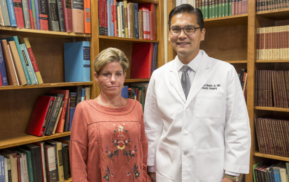 Patient Kelly Davis with Reuben Bueno Jr., M.D., who performed a complex surgery on her face to restore movement to one side. (photo by John Russell)