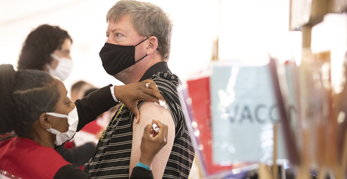 LaKeysha Houston, a student pharmacist, gives a flu shot to Lacy Blanton III at last week’s Flulapalooza event on the VUMC campus. Nearly 10,000 faculty, staff, postdoc scholars and students were vaccinated.