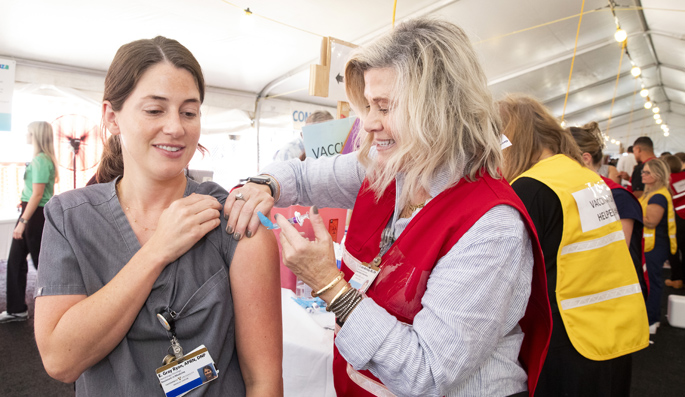 Gray Ryan, APRN, DNP, gets a flu shot from Kate Morrissey, RN, CPN, at last week’s Flulapalooza on the VUMC campus. This year, 10,603 faculty, staff, postdoc scholars and students were vaccinated. (photos by Susan Urmy)
