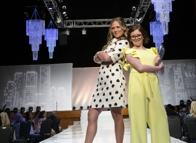Catherine Terry and daughter, Callie, pose at the end of the runway at the annual Friends & Fashion show. 
