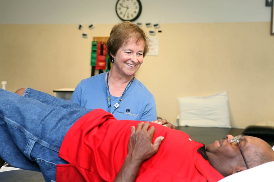 Longtime physical therapist Sheila Gaffney, P.T., M.S., works with patient Jerry Patterson at the Vanderbilt Orthopaedic Institute. (photo by Susan Urmy)