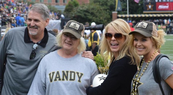 Altruistic donor Andrea Pierson, second from right, received a game ball during the recent Vanderbilt-Florida football game as part of the Gift of Life Tailgate honoring local living kidney donors. On hand were, from left, her husband, James Pierson, mother, Sue Colvin, and sister, Heather McDowell. (photo by Jeff Hanie/IMG)
