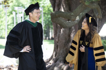 James Crowe Jr., MD, talks with advisee Elaine Chen at the Graduate School ceremony.