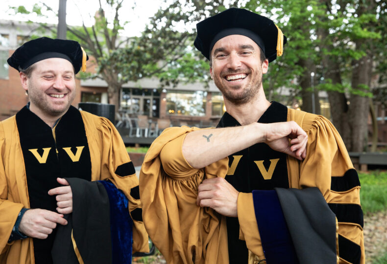 Matthew Vukovich, PhD (Microbe-Host Interactions), shows off his antibody tattoo and shares a laugh with Steven Wall, PhD (Microbe-Host Interactions). Vukovich and Wall conducted antibody-related research in the Vanderbilt Vaccine Center. (photo by Erin O. Smith)