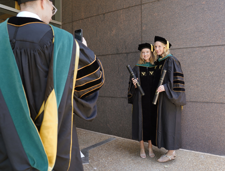 Jessica Giles,MD, left, and Rachel Goddard,MD, get their photo taken following the VUSM ceremony.
