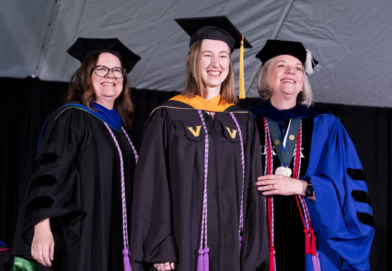 Sophia Berryhill, center, was the first-ever Master of Nursing graduate to receive a VUSN hood. She is flanked by Mary Ann Jessee, PhD, RN, left, and Mavis Schorn, PhD, CNM. (photo by Susan Urmy)