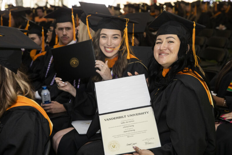 Master of Nursing graduates Christina Devereaux and Indika-Sha DePriest show off their diplomas. (photo by Susan Urmy)
