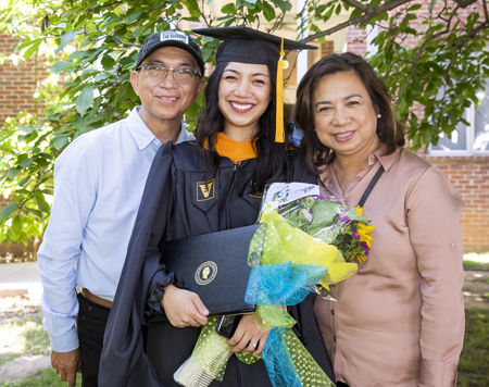 Therese Ungriano poses for a photo with her parents, Perry and Theresa Ungriano, following the VUSN ceremony.