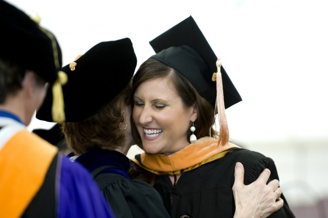 Laurin Revere smiles after being hooded at the School of Nursing ceremony. (photo by Susan Urmy)