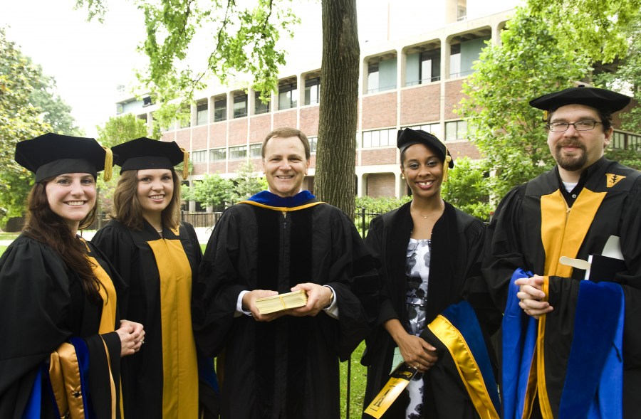 Graduate school faculty marshal Joey Barnett, Ph.D., center, with, from left, Teresa Croce, Melissa Carter, Keri Day and Joshua Davis. (photo by Susan Urmy)