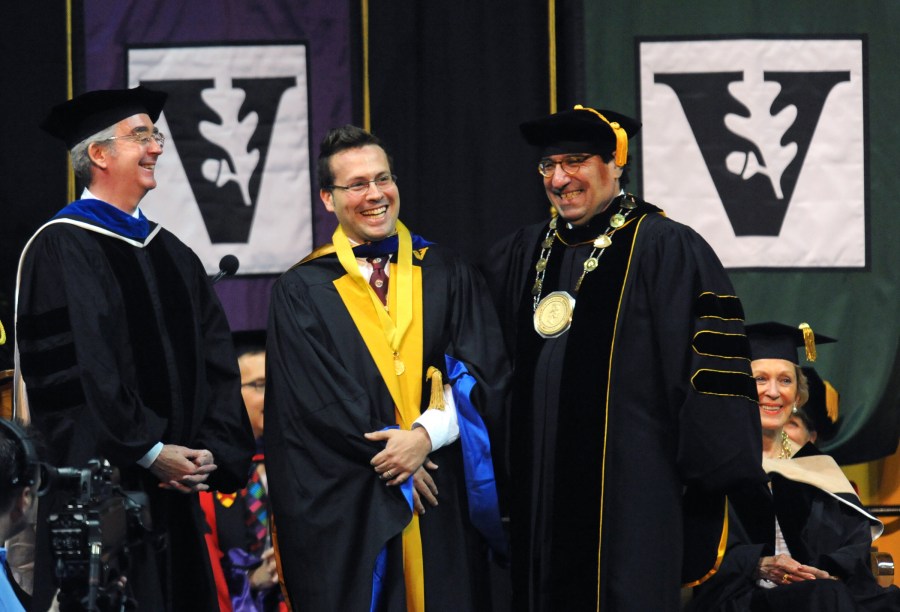 Joshua Buckholtz, center, who earned his degree in Neuroscience, received the Graduate School’s first Founder’s Medal from Dennis Hall, Ph.D., vice provost for Research and dean of the Graduate School, left, and Chancellor Nicholas S. Zeppos. (photo by Joe Howell)