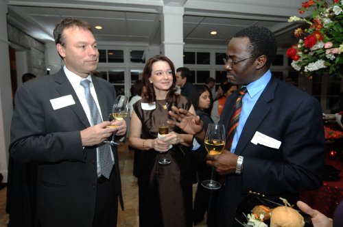 Jeff Balser, M.D., Ph.D., left, and Julie Hudson, M.D., talk with UNICEF’s René Ekpini, M.D., M.P.H., at an event following the conference. (photo by Anne Rayner)