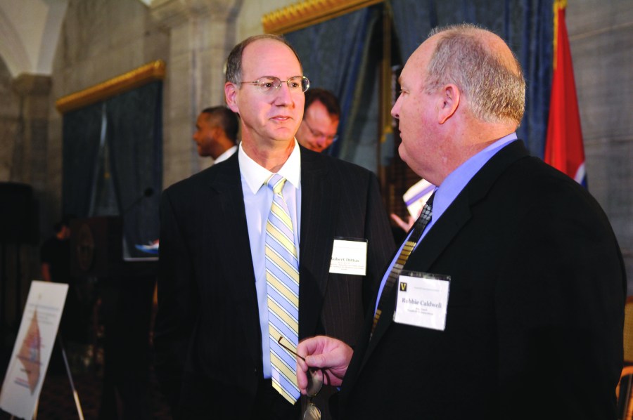 Robert Dittus, M.D., MPH, left, talks with Vanderbilt football coach Robbie Caldwell at Monday’s event. (Photo by Anne Rayner)