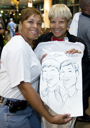 Schronda Grimes, patient services rep, left, and her mother,  Alycia Buford, administrative assistant, show off their caricature. (photo by Joe Howell)