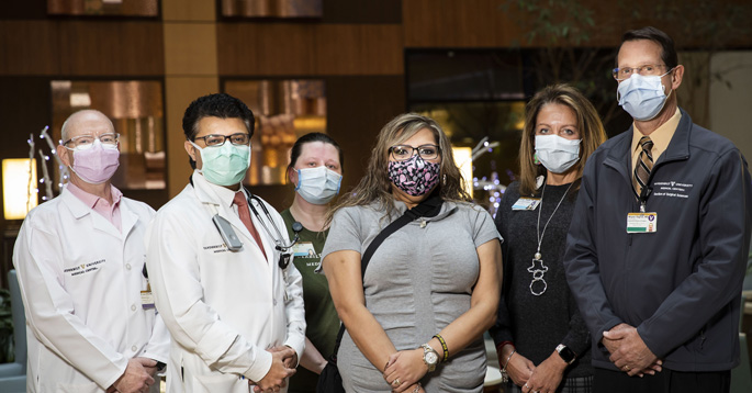 Patient Veronica Llamas-Barajas (light gray shirt) with members of her care team, from left, Casey West, MSN, ANP-BC, Sandip Zalawadiya, MBBS, Jessica Hassler, RN, Wendy Tarpley, RN, and Wayne English, MD.