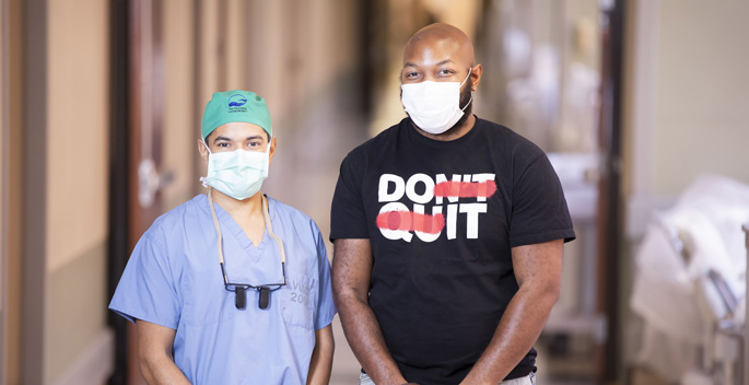After a brachial plexus injury caused Delvonte Mayberry, right, to lose use of his right arm, Mihir Desai, MD, performed a complex reconstruction of the nerve network.